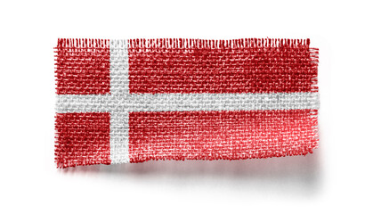 Denmark flag on a piece of cloth on a white background
