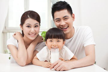 A happy family of three and milk 