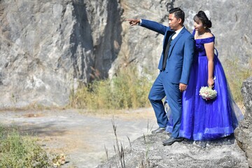 Asian wedding couple at the rocky background
