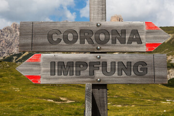 Schilder mit Corona und Impfung