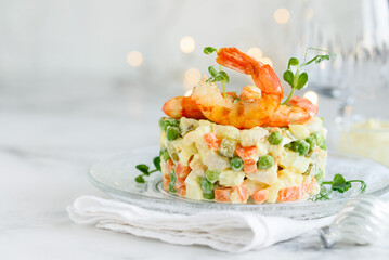 Olivier salad with shrimps. Traditional Russian festive salad. Selective focus. Copy space