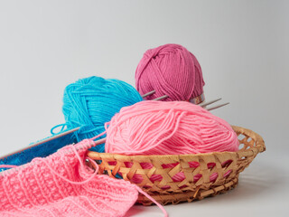 Needlework crochet, top view of yarn balls, flat spoon on light wood close-up