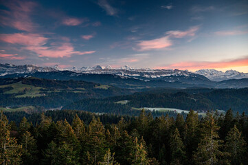 Fototapeta na wymiar Bernese Alps at an autumn sunset with the hills of Emmental in front