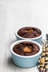 Hot chocolate lava cake in clay pot on wooden table
