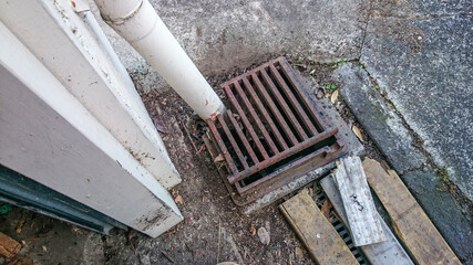 Clogged sink pipe next to an ageing wood from the garage