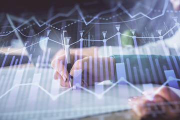 Double exposure of forex chart drawing over people taking notes background. Concept of financial analysis