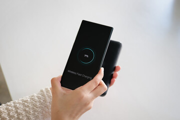 Female Charging Smartphone Using portable Wireless fast Charging  at work