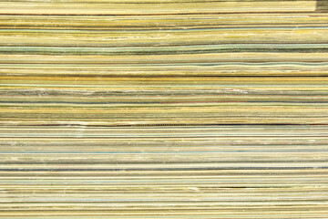 A stack of old magazines with shabby pages background.