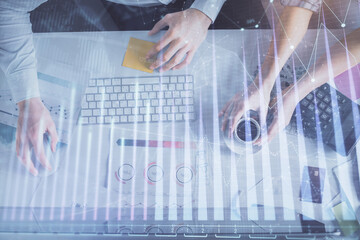 Double exposure of man and woman working together and financial chart hologram drawing. market analysis concept. Computer background. Top View.