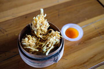 Special side dish: Fried shrimp dim sum with sauce on wooden table