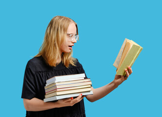 Studio portrait of a joyful Caucasian student with books in hands.
