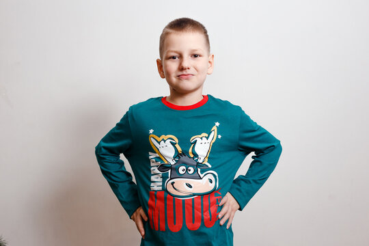 smiling nine-year-old boy in green pajamas with a picture of cow. happy new year. year of the cow. Chinese New Year