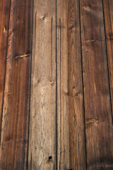 Background: old weathered wood texture with figure and knotholes, brown