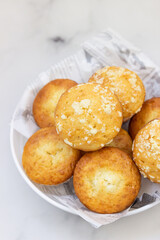 Freshly baked tasty vanilla muffins and muffins with crumble topping. Light background. Top view.