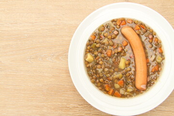 delicious freshly made lentil soup with a sausage