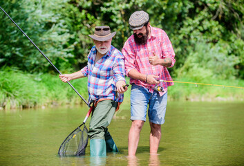 who has more. father and son fishing. hobby and sport activity. Trout bait. two happy fisherman...