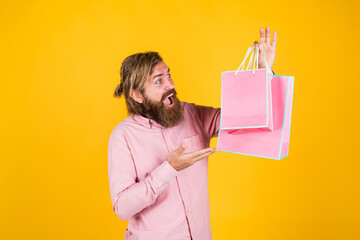 Easy and fast. man with package. prepare for holidays. best sale offer. happy bearded man with present pack. cheerful brutal hipster hold gift. paper shopping bag. birthday surprise at party