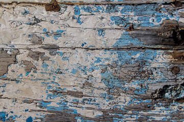 wooden board with traces of white and blue paint