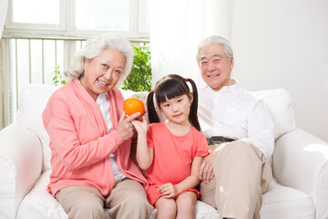 Happy grandparents and grandchildren are playing in the living room 