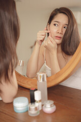 Obraz na płótnie Canvas Young asian beauty woman having acne problem on her face.