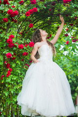 Obraz na płótnie Canvas Dreamy girl ballroom dress in rose garden, fairy tale concept