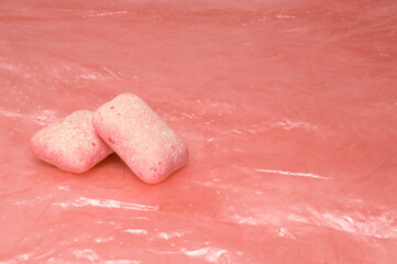 left watermelon chewing gum on a pink background