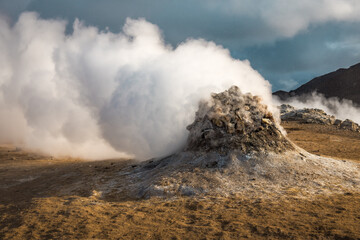 Hverir geothermal area in the north of Iceland near Lake Myvatn. Smoking fumaroles and cracked multi colored ground around.