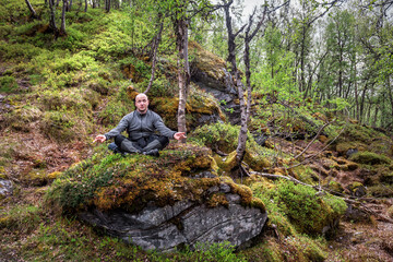 Obraz premium man meditates in the forest