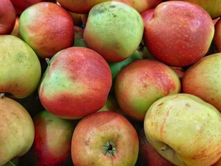 Fresh natural apples on top of each other in the market