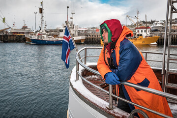 Professional fisherman in winter Iceland port