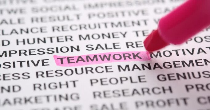 Pink highlighter pen marks word teamwork. Macro shot, selective focus. human analyze information and highlight the word for interpretation.