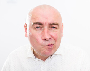 portrait of bald adult mature man with emotions on white background