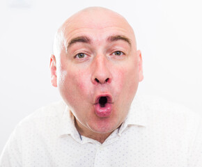 portrait of bald adult elderly man with emotions on white background