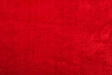 Red artificial fur or plush plaid surface. Faux fur background of purple color.