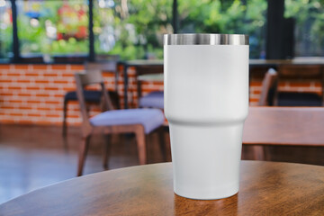 Mockup white coffee mug on table in restaurant and cafe