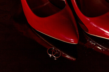 Wedding red shoes and ring. Close-up. Red shoes.
