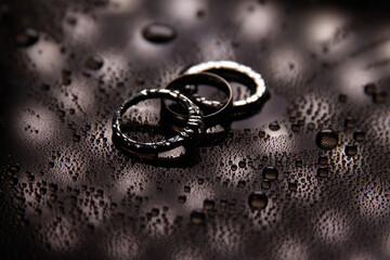 Three wedding rings. The rings are highlighted with beautiful light. One ring has a diamond. Wedding rings as the main attribute of a wedding day