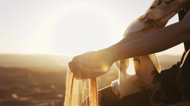 Woman'S Hands Holding And Letting Go Of Desert Sand