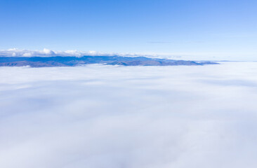 Fototapeta na wymiar Aerial drone shot of flying above clouds
