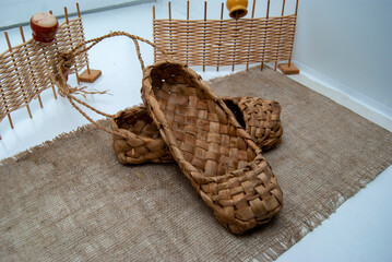 Museum exhibit-a copy of an old wicker shoe. Russian bast shoes.