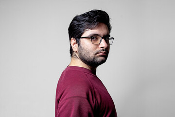 A man looking backwards turning towards camera