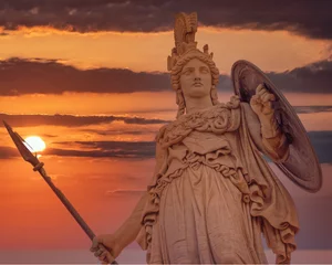 Selbstklebende Fototapeten Athena statue the ancient Greek goddess of wisdom and knowledge illuminated by dramatic sun burned sky, Athens Greece © Dimitrios