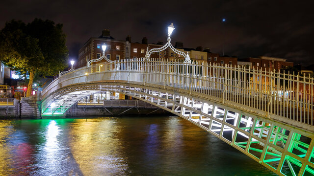 Dublin - August: Night view of famous illuminated Ha Penny Bridge