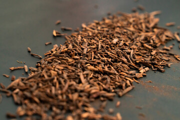 A pile of cloves for cigarette flavor close up isolated on a black background