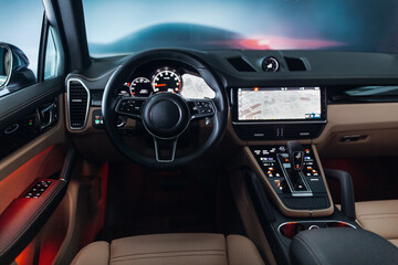 Fototapeta premium Expensive suv car interior with the steering wheel, multimedia dashboard, and gearbox handle