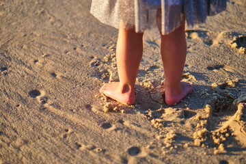 Footprints in the sand. The feet of the mother and child walk along the shore. Summer memories. Plzha by the sea. High quality photo