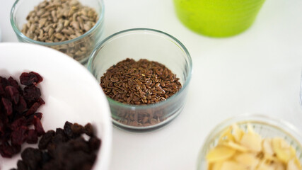 bowl of linseed with granola ingredients around