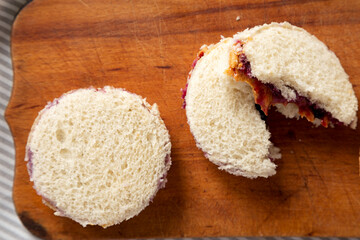 Homemade Crustless Peanut Butter  and Jelly Circles on a rustic wooden board, overhead view. Close-up.