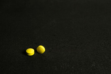 Colorful pills over dark background