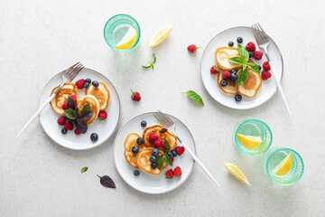 Pancakes with fresh blueberry and raspberry served for healthy vegetarian breakfast